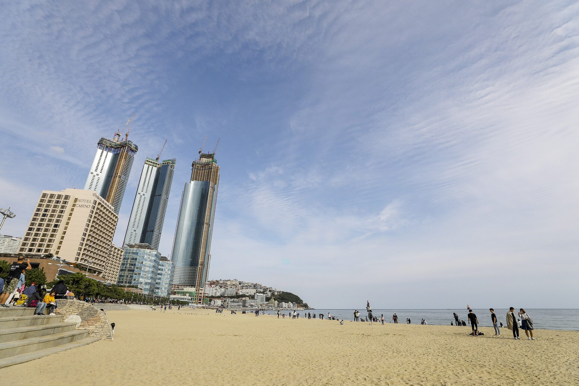 Sandy Haeundae Beach on a clear day, with the glass towers of Marine City rising behind the sand