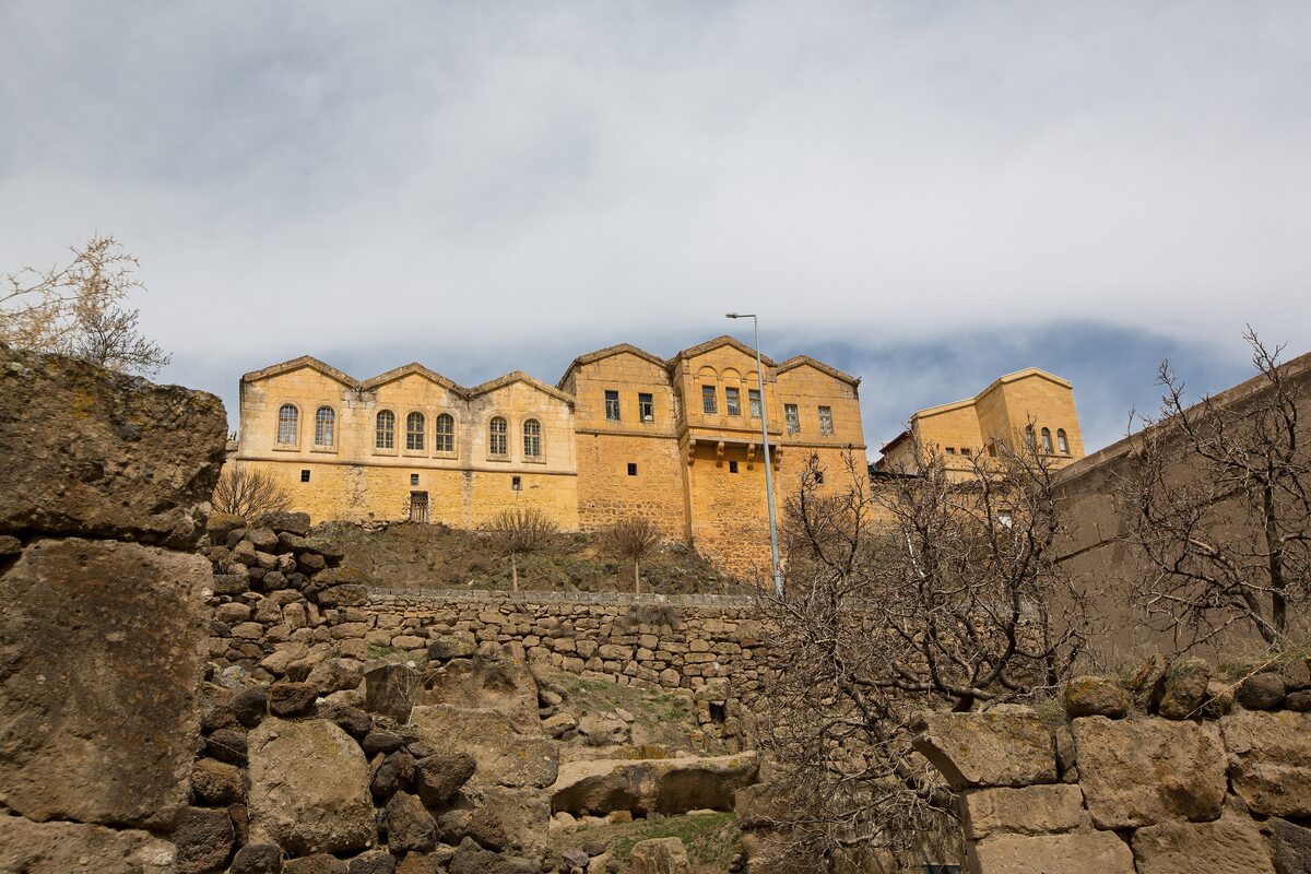 Honey-colored stone mansions of Güzelyurt above old stone walls