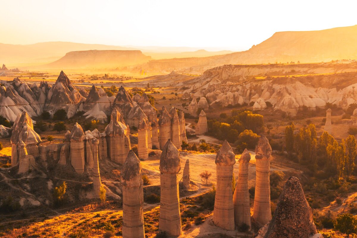 The tall capped rock pillars of Love Valley glowing gold at sunset