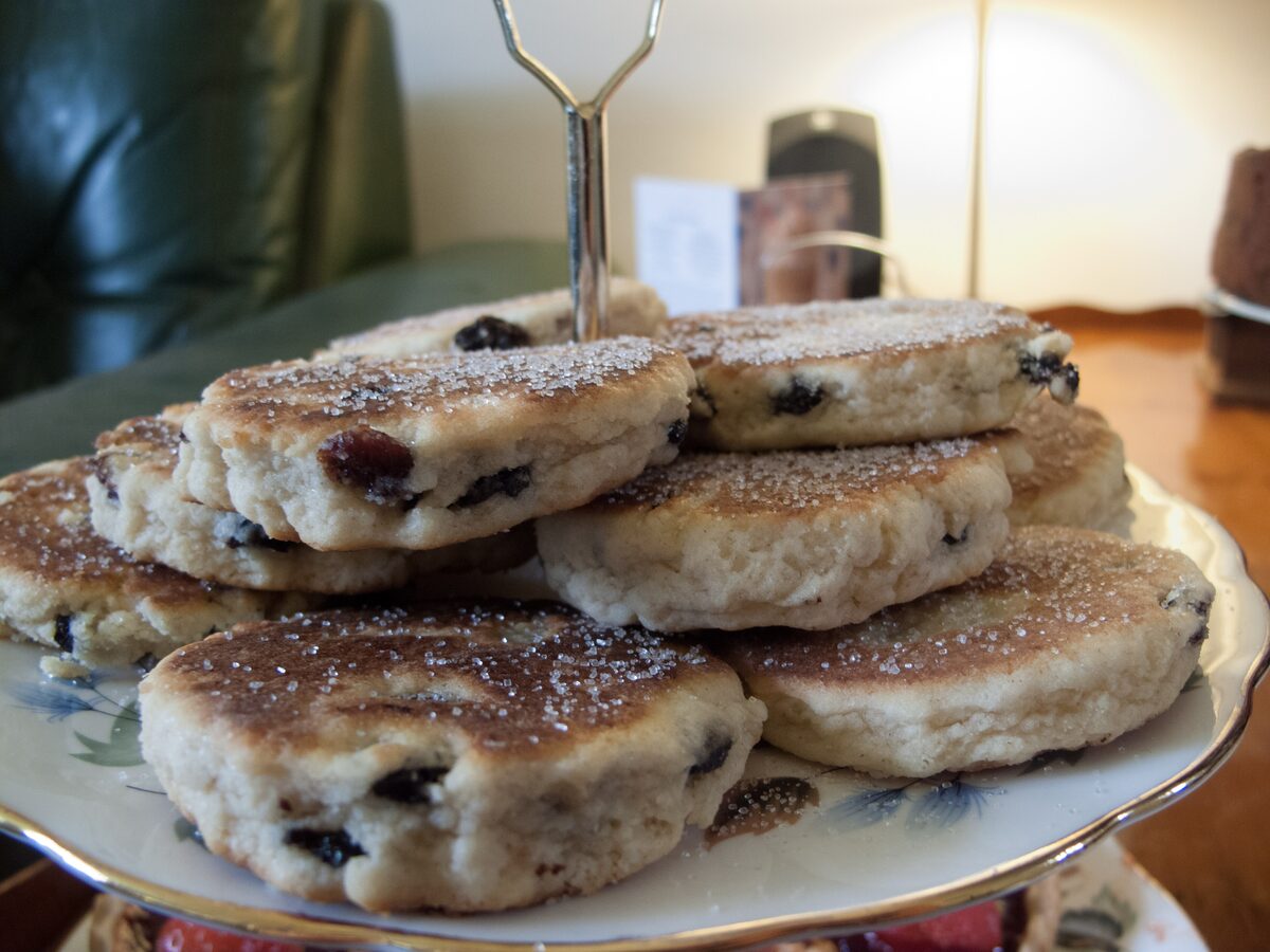 A stand of Welsh cakes, flat round griddle cakes with currants dusted with sugar