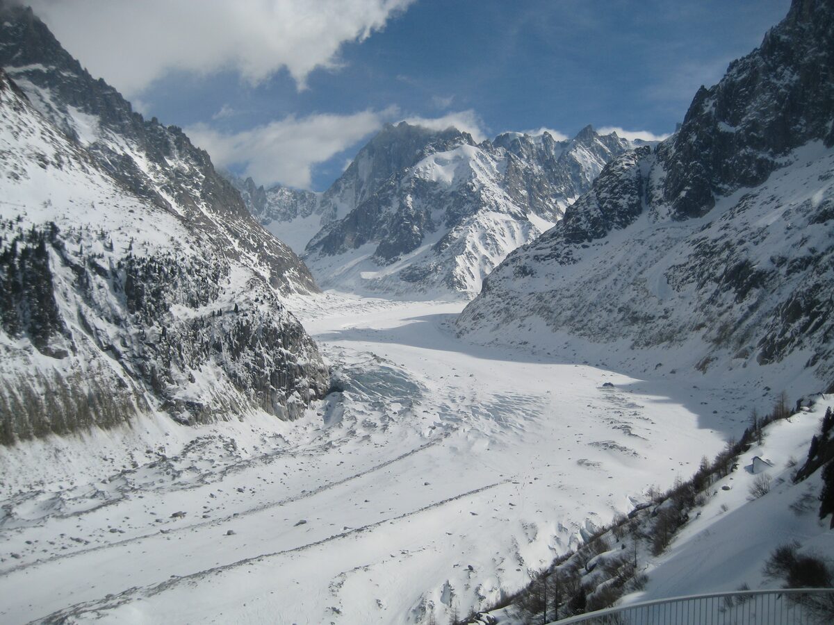 The Mer de Glace in winter, its snow-dusted ice running down between the surrounding peaks