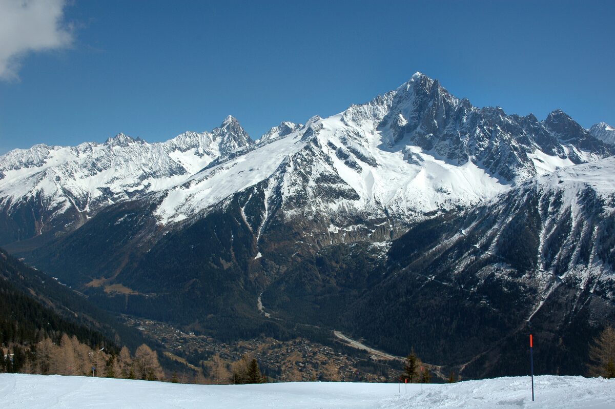 The snowy Aiguille Verte and the Chamonix needles seen from the Planpraz ski slopes on the Brévent side, with the valley far below