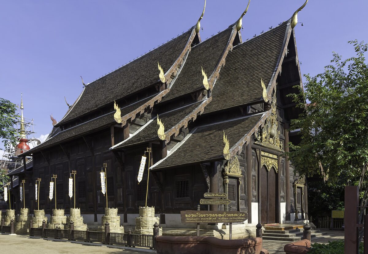 The dark teak wihan of Wat Phan Tao with its layered roofs and carved gables