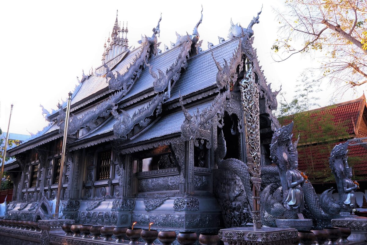 The dark wooden side of Wat Sri Suphan, the Silver Temple, with its ornate carved panels