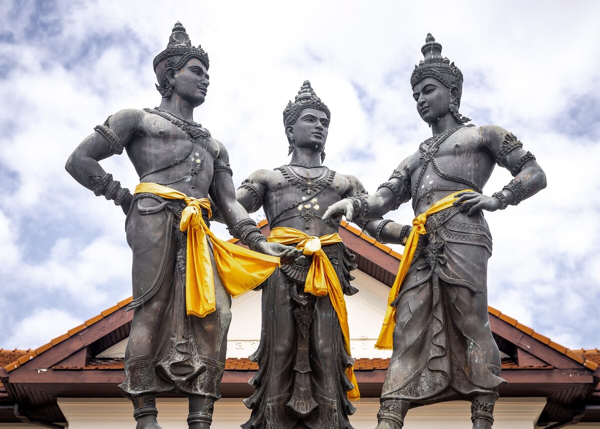 The bronze Three Kings Monument, with yellow sashes, on the square in front of the Historical Centre