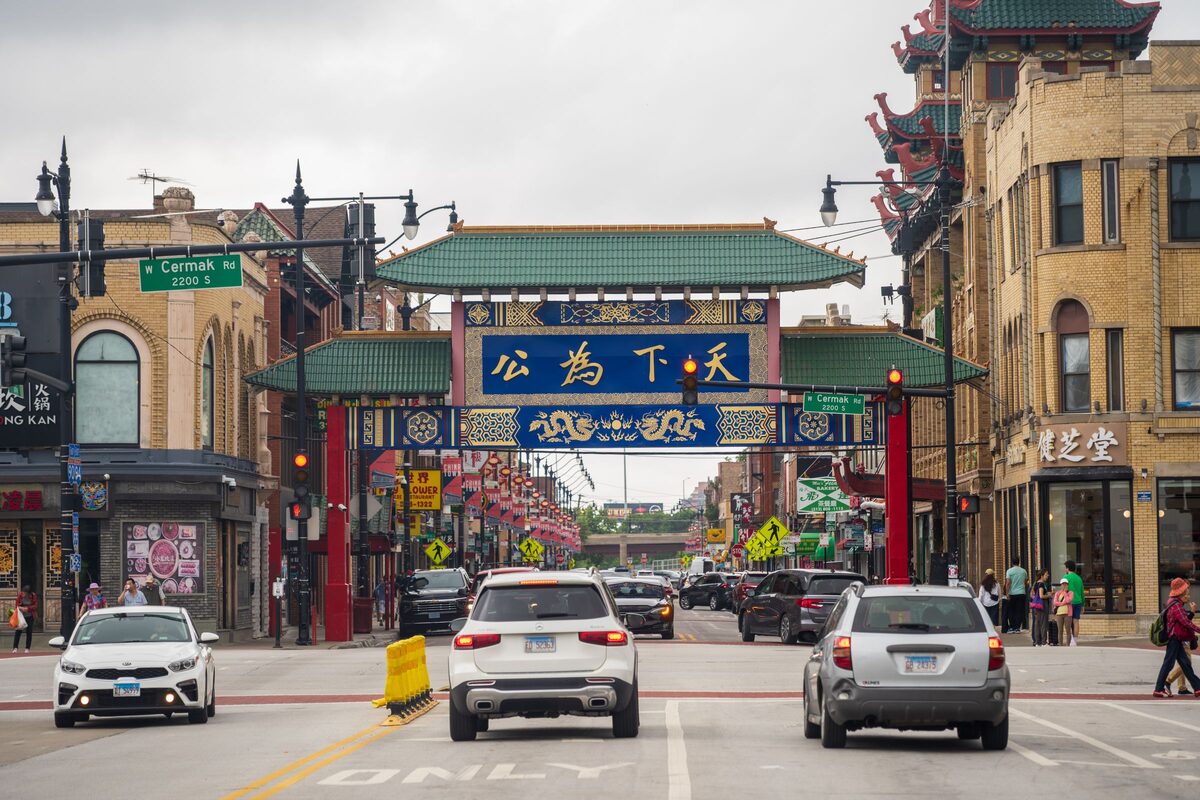 The Chinatown Gate on Wentworth Avenue, with its green tile roofs and blue and red panels, and cars driving beneath it