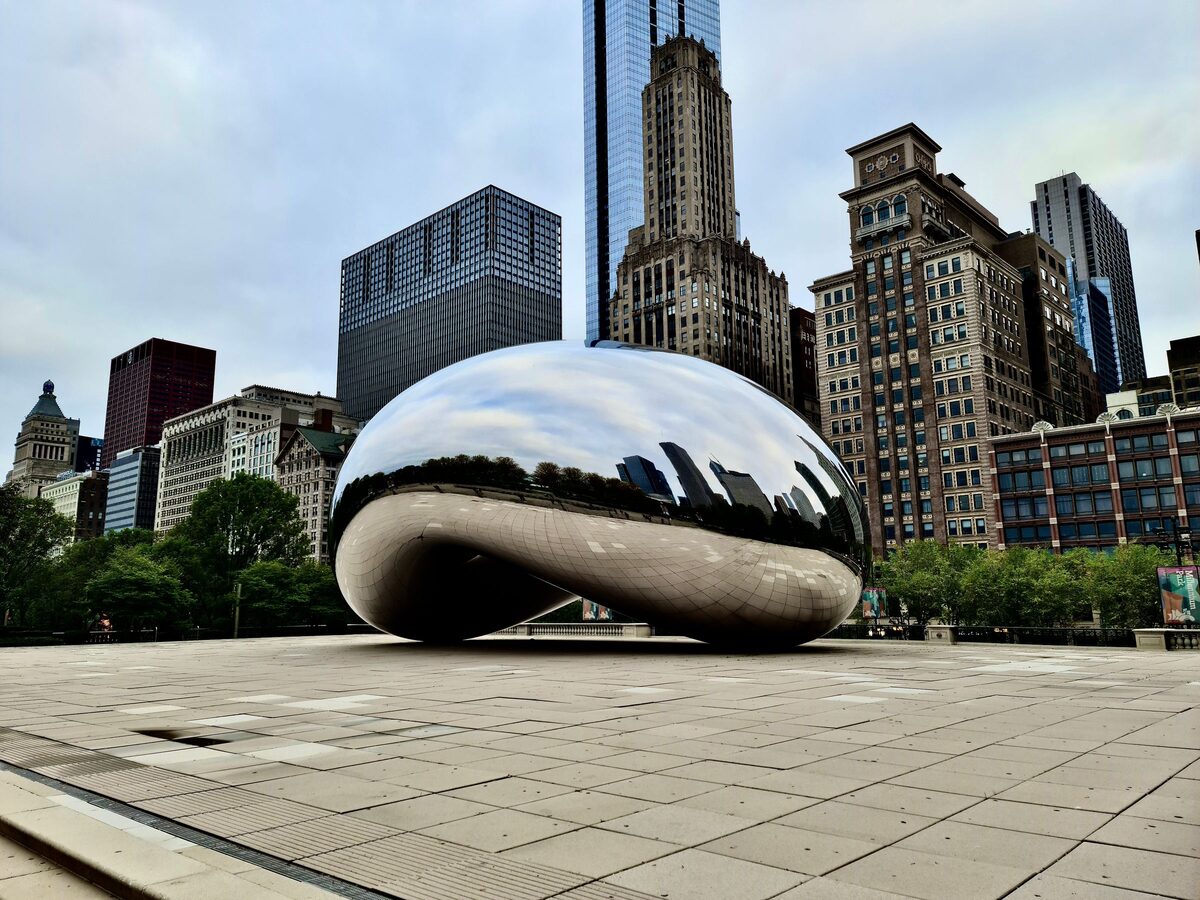 Cloud Gate, the mirror-polished sculpture known as the Bean, with Chicago's skyscrapers rising behind it
