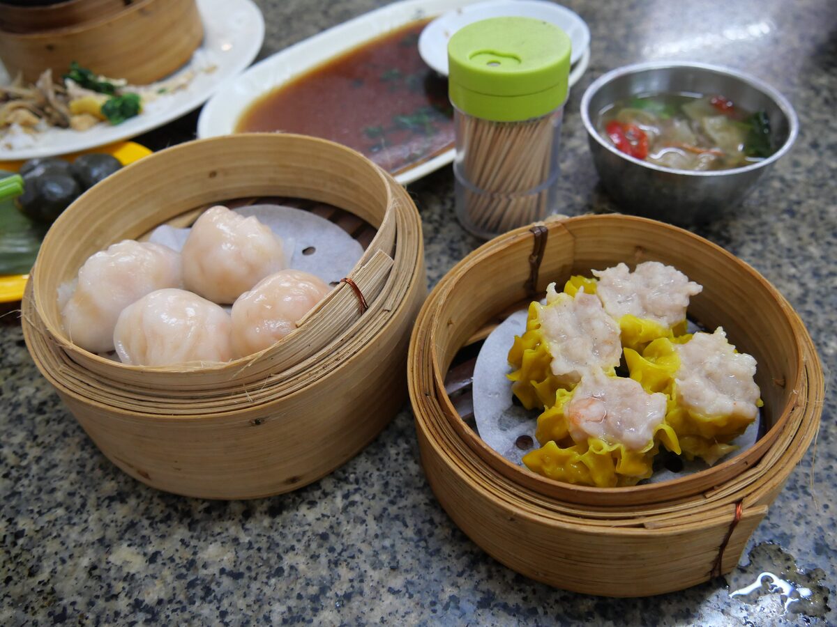 Bamboo steamers of har gow and shrimp shumai on a dim sum table