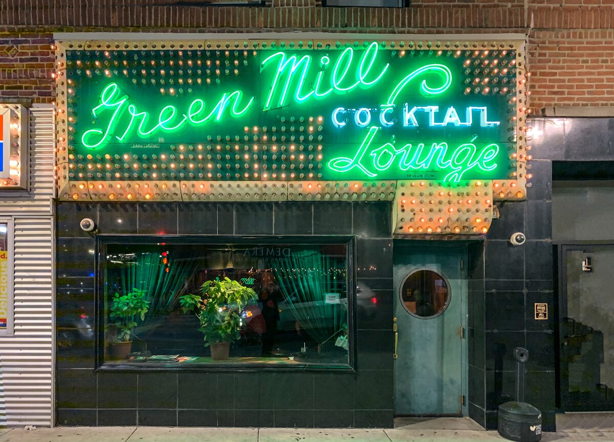 The green neon Green Mill Cocktail Lounge sign above the entrance