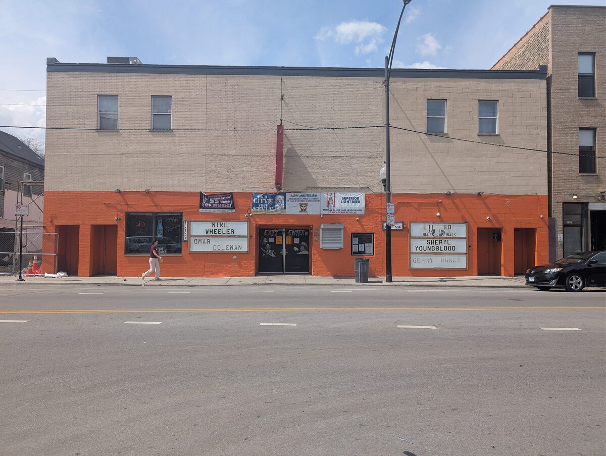 The orange and tan front of the Kingston Mines blues club on a sunny day