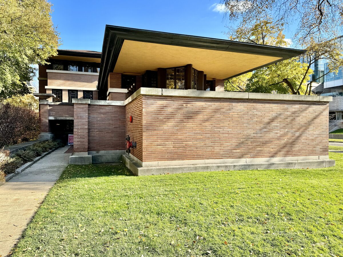 Frank Lloyd Wright's Robie House, with its long low roofs and brick walls, on a sunny autumn day