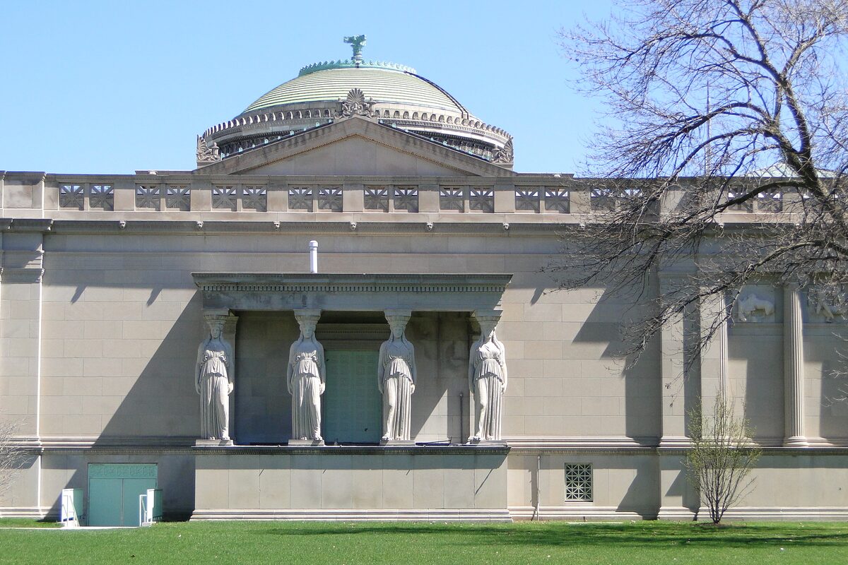 The stone caryatid porch and green dome of the Museum of Science and Industry