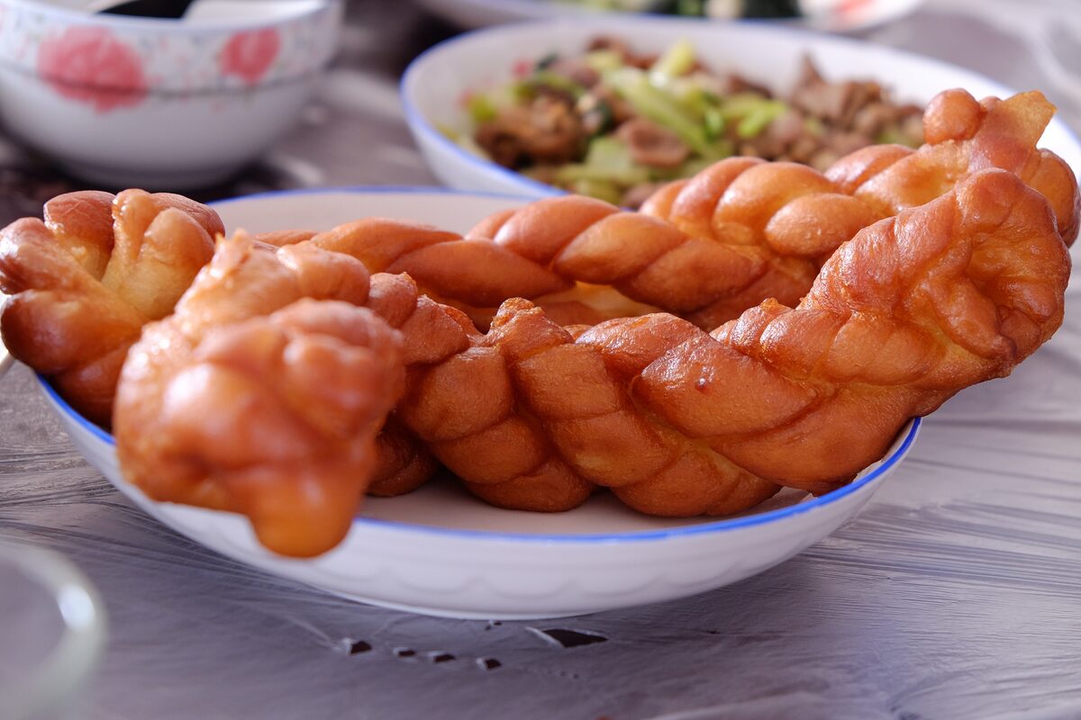 Golden twisted fried-dough mahua on a plate