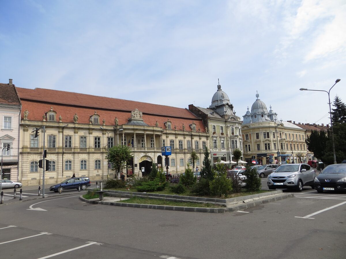 The long baroque front of the Bánffy Palace on Piața Unirii, with its red roof and central balcony