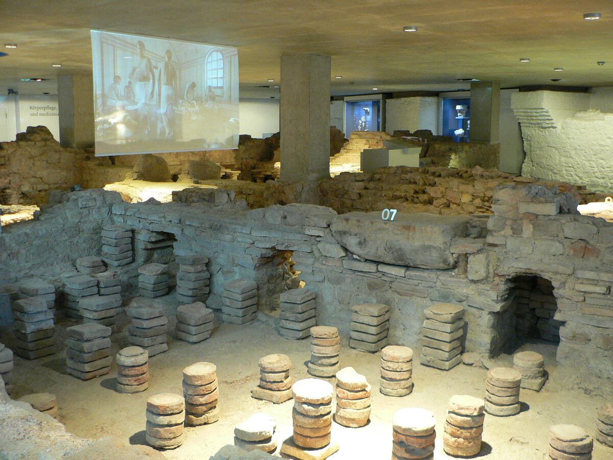 The excavated Roman bathhouse at Zülpich with its brick pillars of the floor heating, under a modern roof