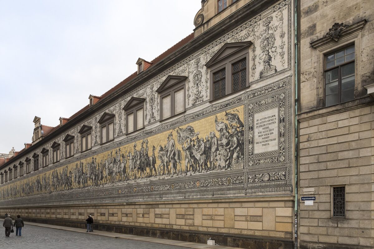 The Fürstenzug, the long porcelain-tile mural of Saxon rulers on the Stallhof wall, in the afternoon light