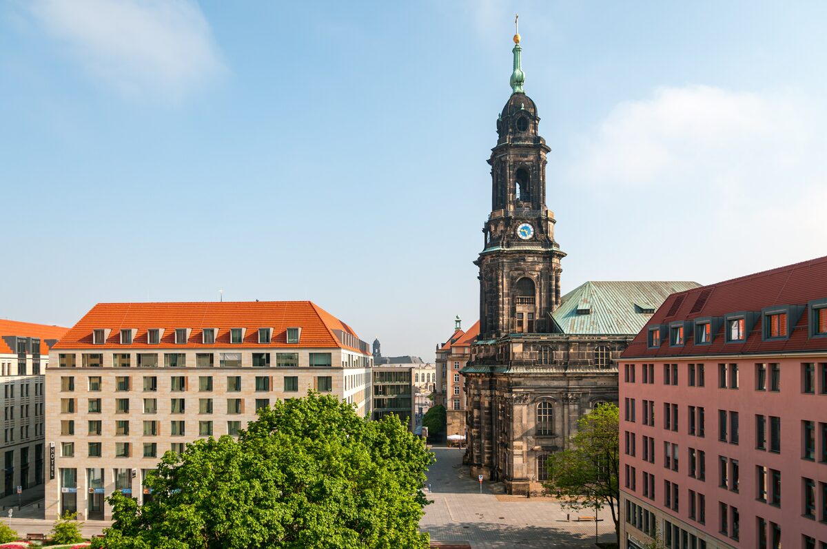 The tower of the Kreuzkirche rising above the streets around the Altmarkt on a clear day
