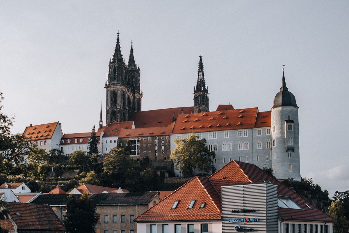 The Albrechtsburg and the twin spires of Meissen Cathedral on their rock above the red roofs of the old town