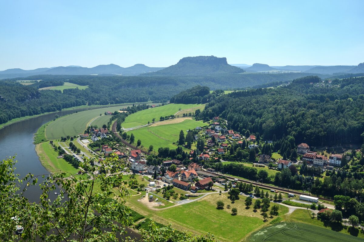 Looking down from the Bastei on the village of Rathen, the bend of the Elbe and the flat-topped Lilienstein