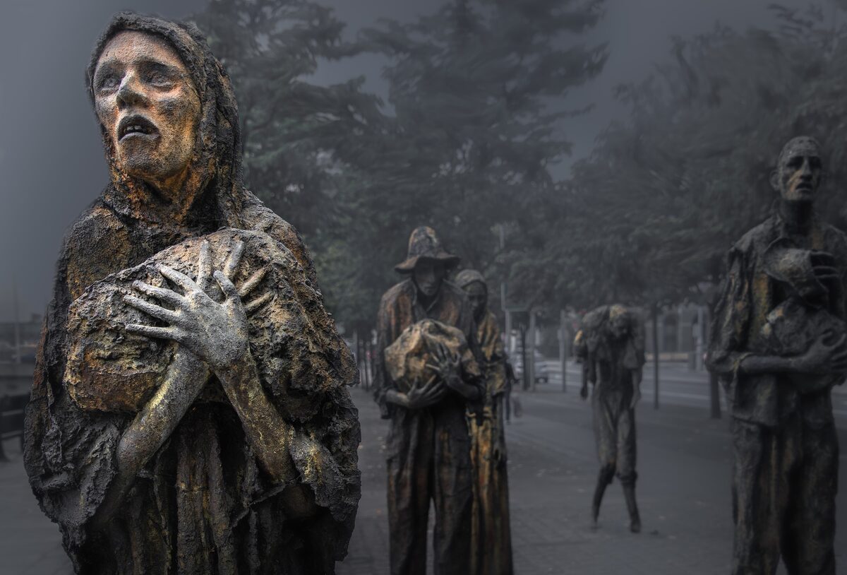 Rowan Gillespie's bronze famine sculptures on Custom House Quay: thin, ragged figures walking towards the ships, with a woman clutching her chest in front