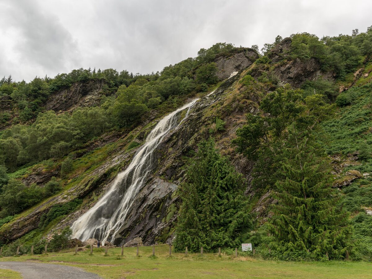 Powerscourt Waterfall pouring down a steep wooded hillside in the Wicklow Mountains