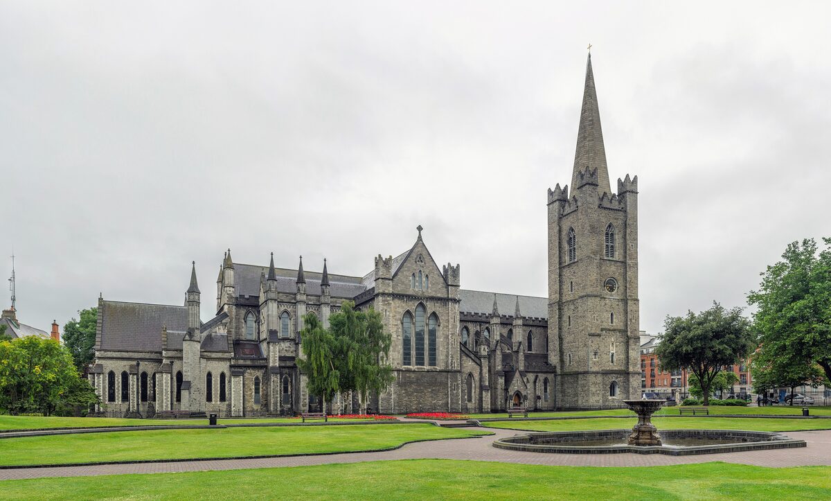 St Patrick's Cathedral in Dublin seen across the lawns and fountain of St Patrick's Park, with its tall stone tower and spire