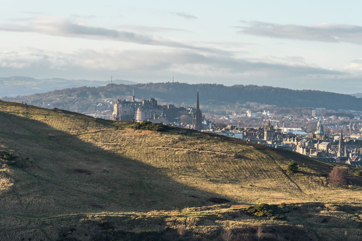 View from the slopes of Arthur's Seat over Edinburgh, with the castle and church spires on the skyline