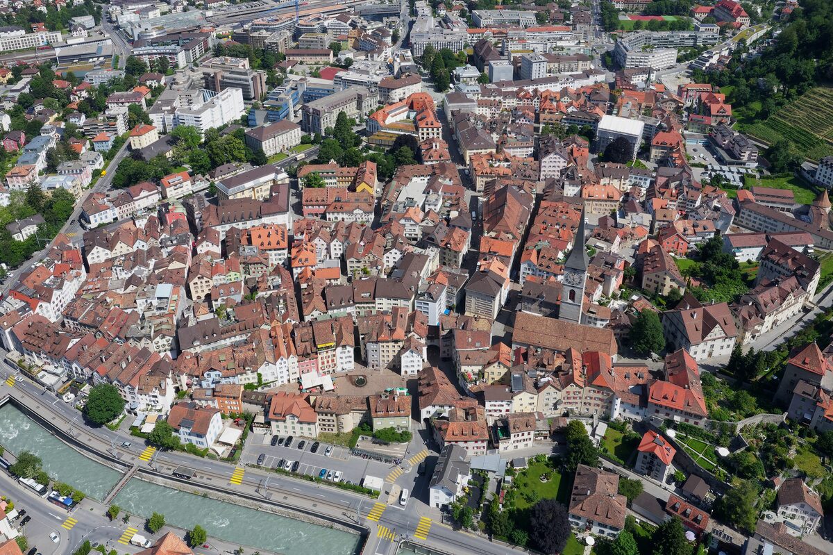 Chur's old town from above: red roofs packed close together beside a river