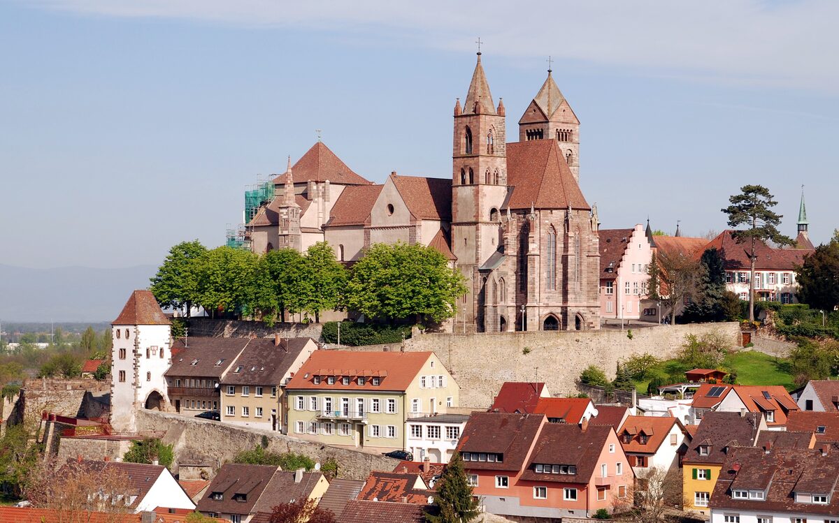 The two towers of St. Stephan's Münster on the hill above the red roofs of Breisach