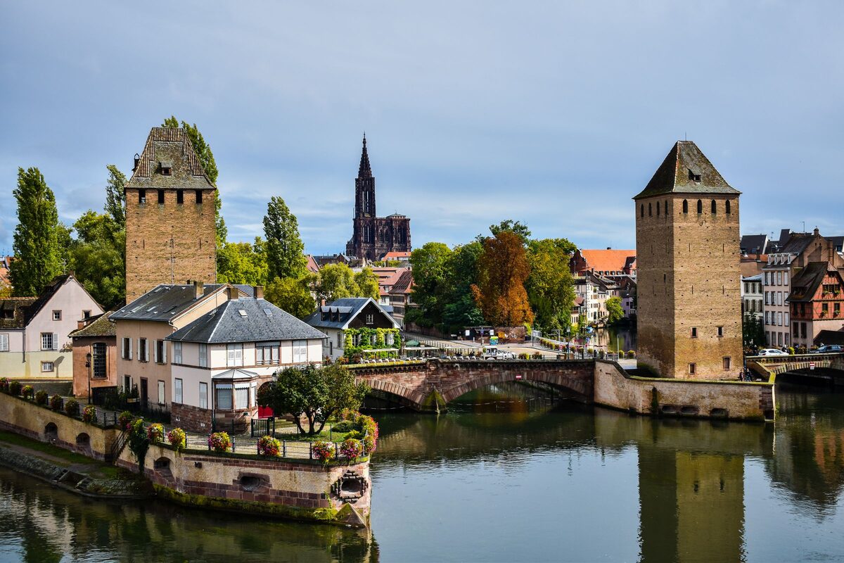 The Ponts Couverts towers on the Ill in Strasbourg, with the cathedral spire in the distance