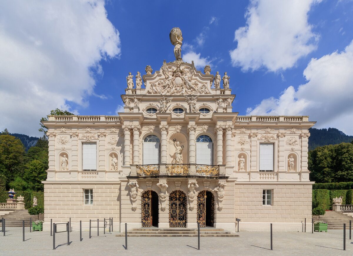South front of Linderhof Palace, its pale facade and gilded ornaments under a blue sky