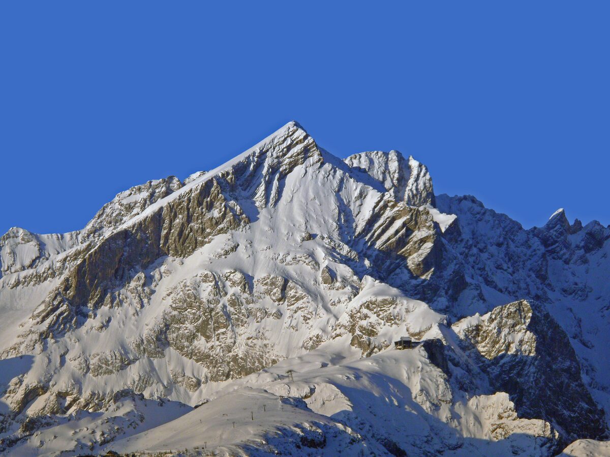 The snow-covered Alpspitze peak in the Wetterstein range on a clear winter day