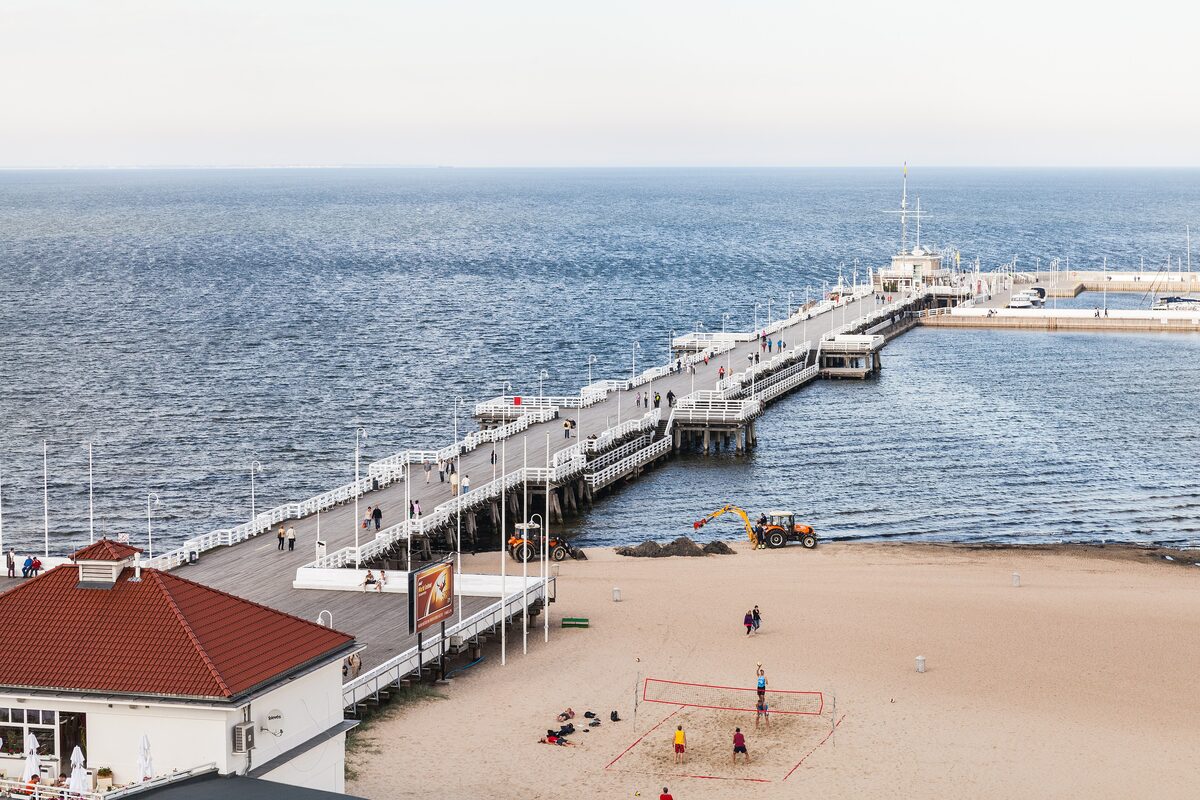 Sopot pier stretching out into the Baltic, seen from above, with the beach in front