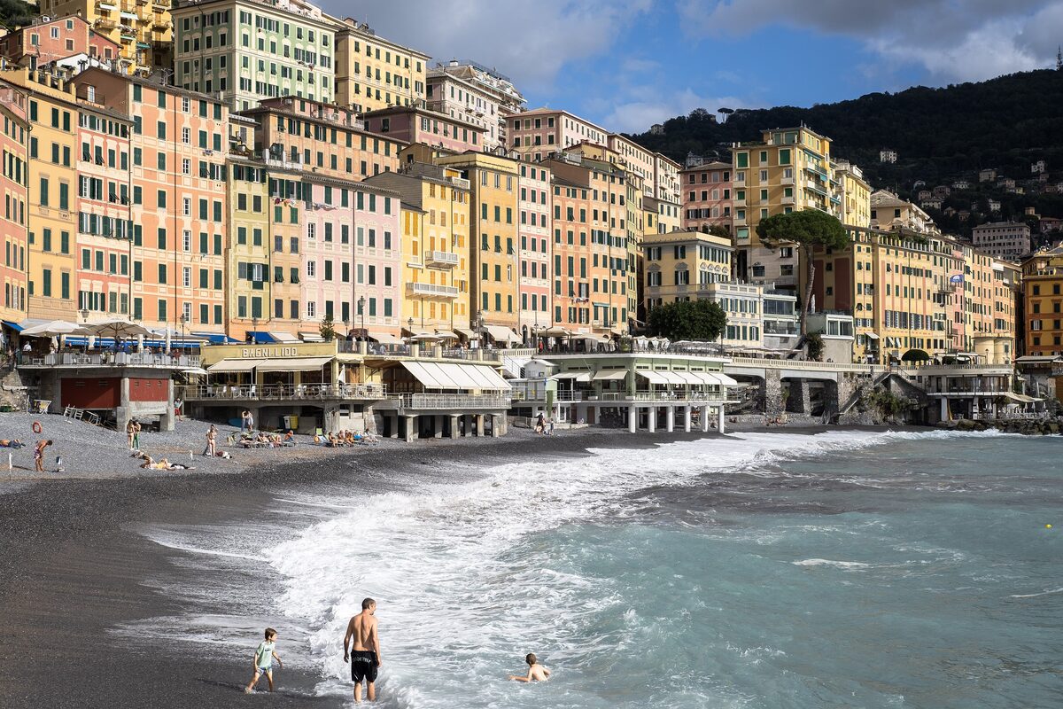 Tall pastel houses above the pebble beach of Camogli