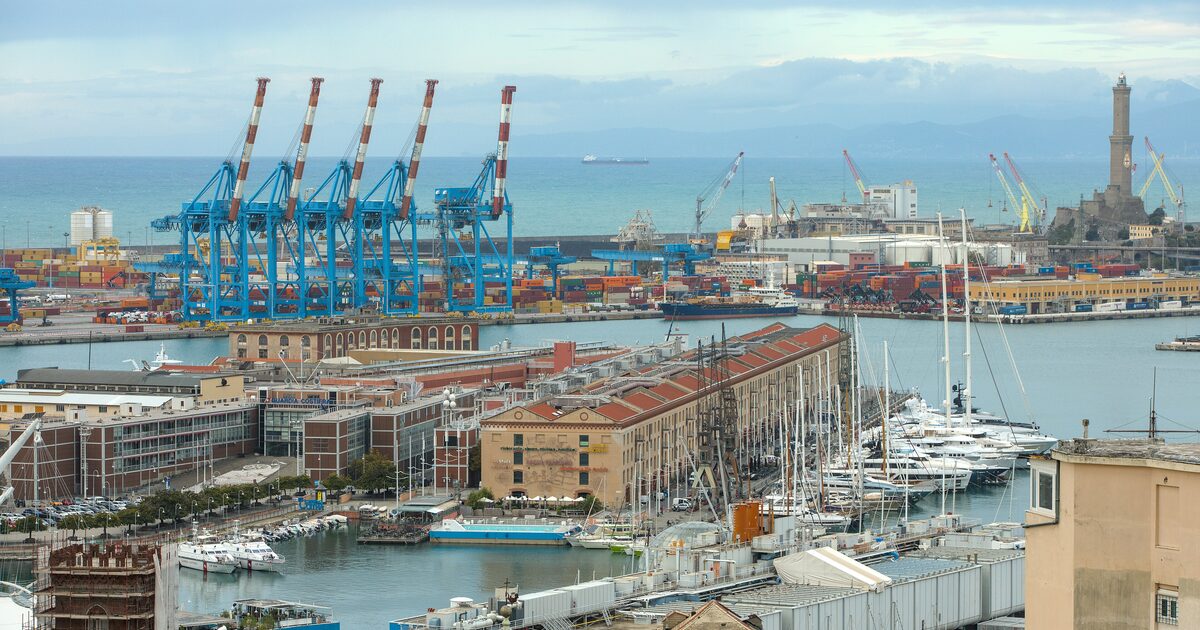 The port of Genoa seen from above, with moored boats, container cranes and the Lanterna lighthouse
