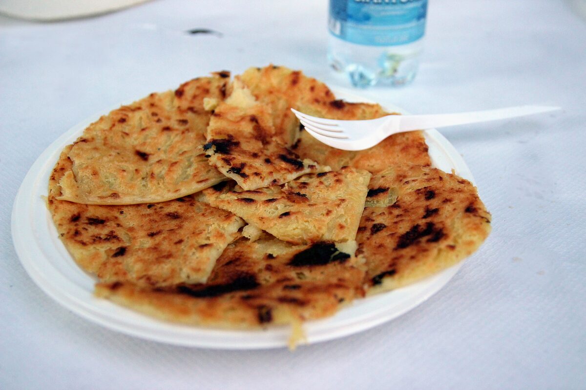 A plate of farinata, the chickpea flatbread, broken into pieces