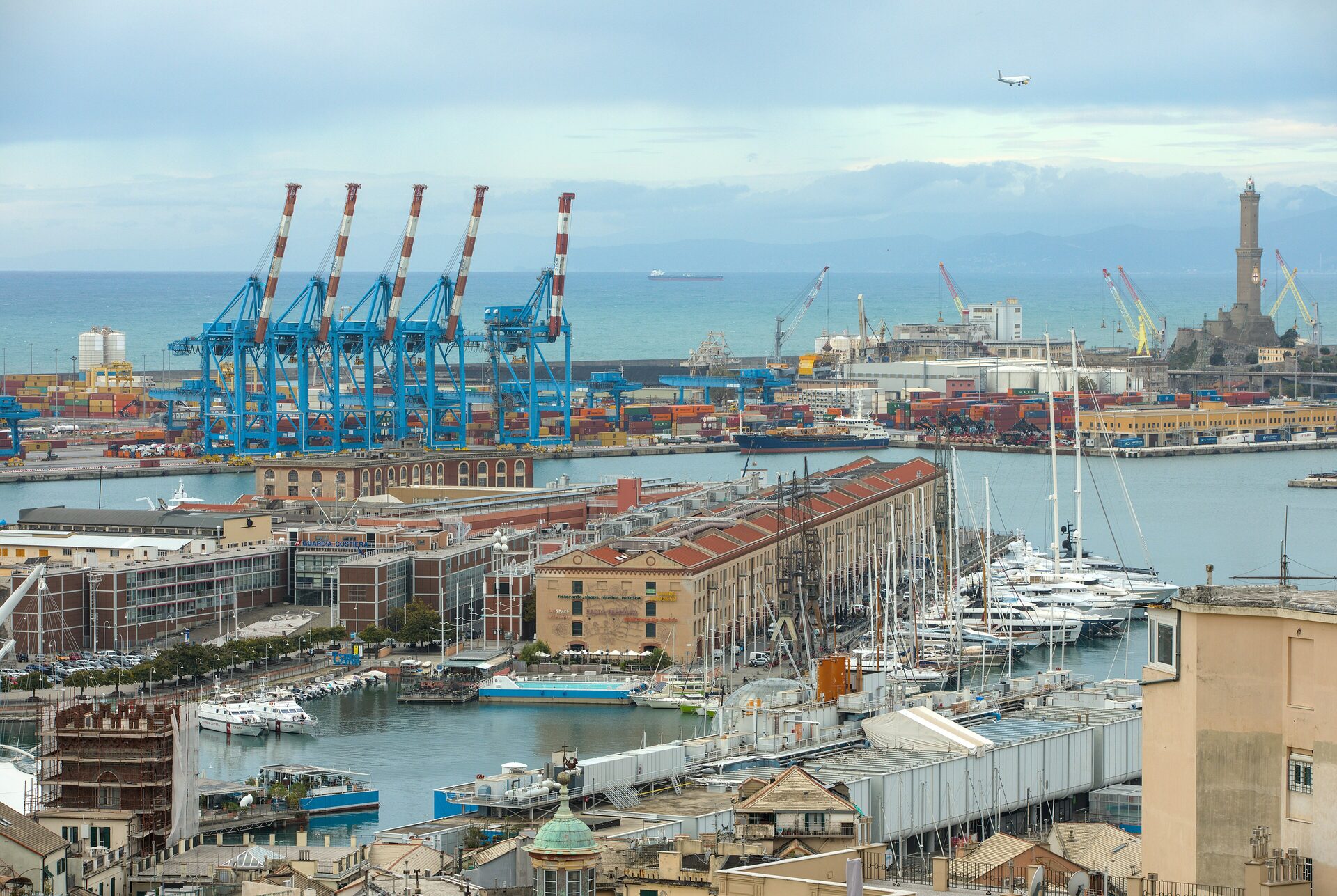 The port of Genoa seen from above, with moored boats, container cranes and the Lanterna lighthouse