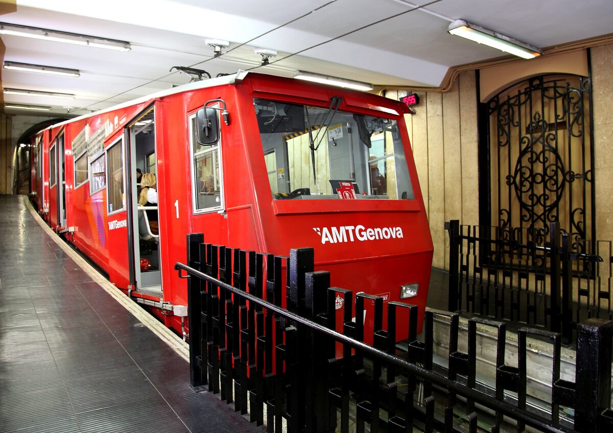 A red funicular car waiting at the Zecca station