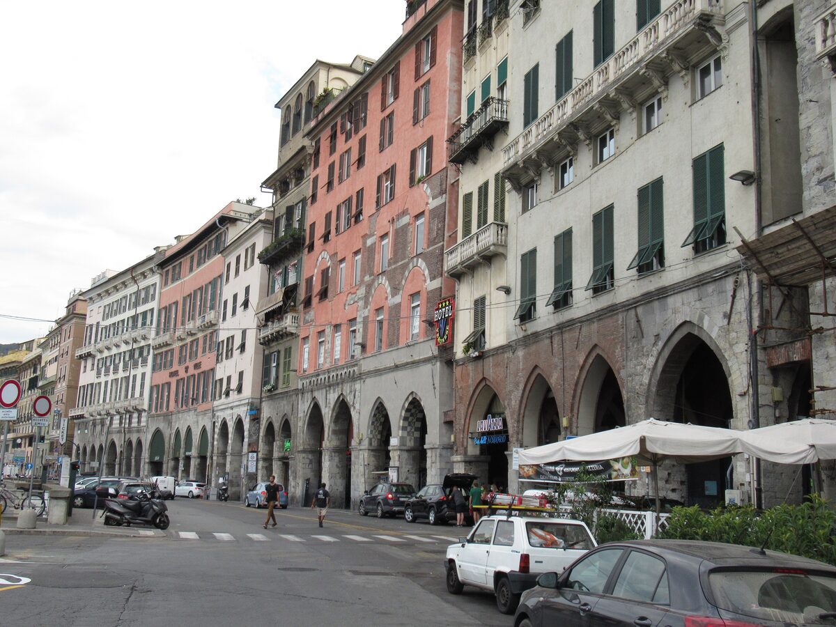 The medieval arcades of Via Sottoripa under tall painted houses