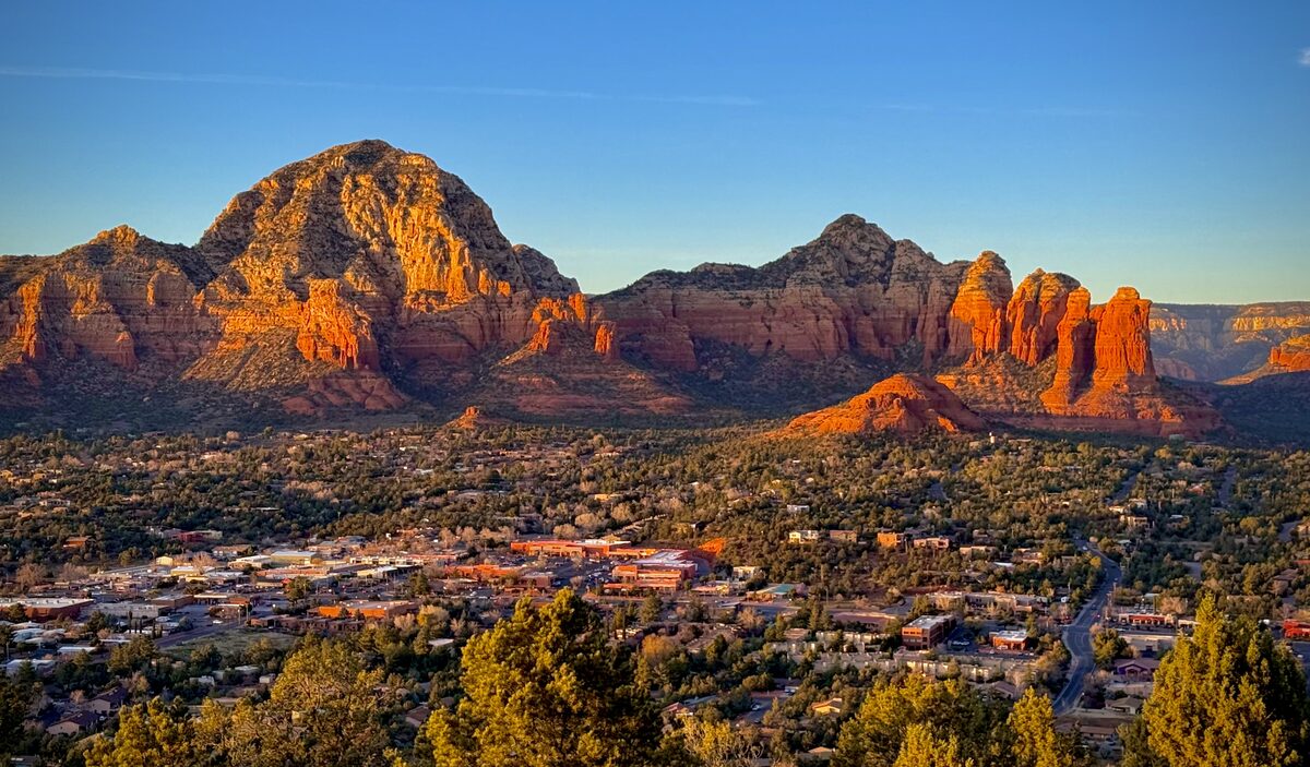 Sedona's red buttes glowing orange at sunset, seen from Airport Mesa