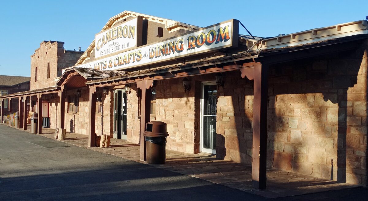 The stone-fronted Cameron Trading Post and its long covered porch at sunrise
