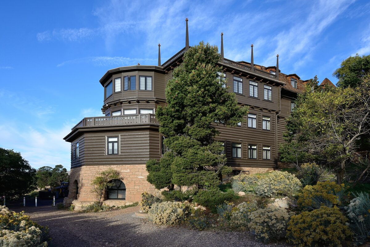 El Tovar hotel's dark timber walls and turret above a garden