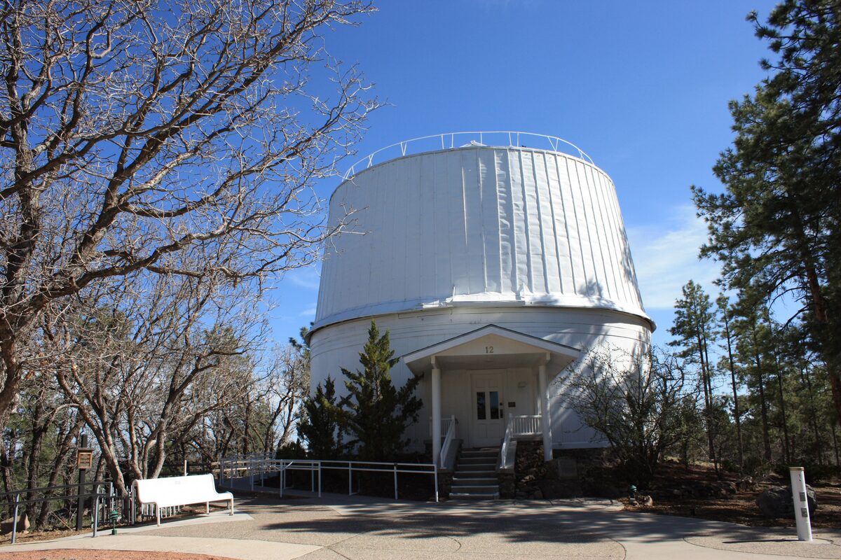 The white Clark Telescope dome at Lowell Observatory under blue sky