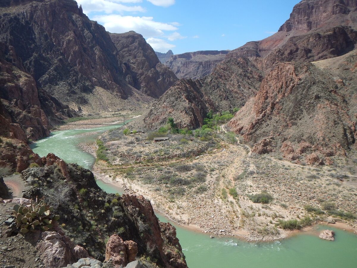 The green Colorado River winding through the dark inner canyon walls