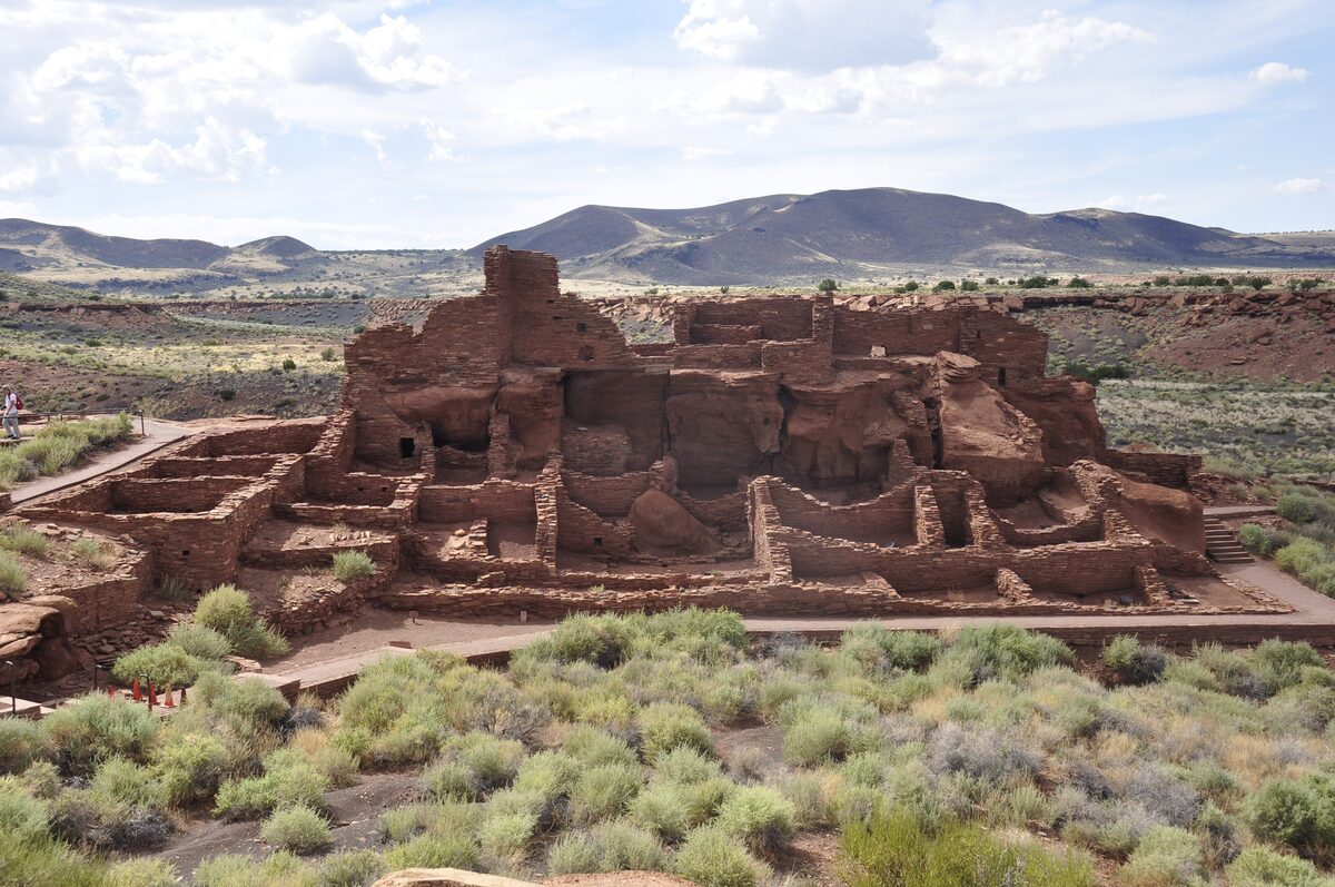 The red sandstone pueblo ruins of Wupatki with distant hills