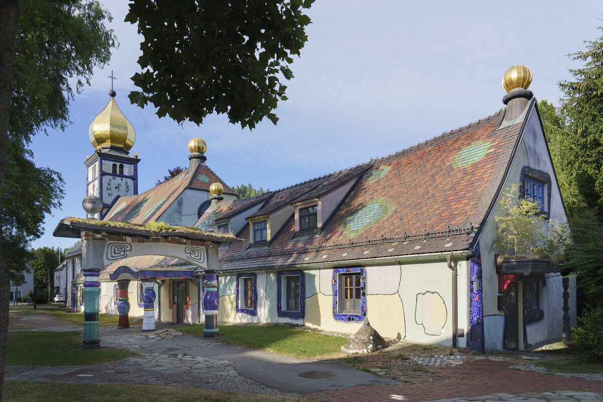 The golden onion domes and colorful buildings around the church of St. Barbara in Bärnbach, redesigned by Hundertwasser