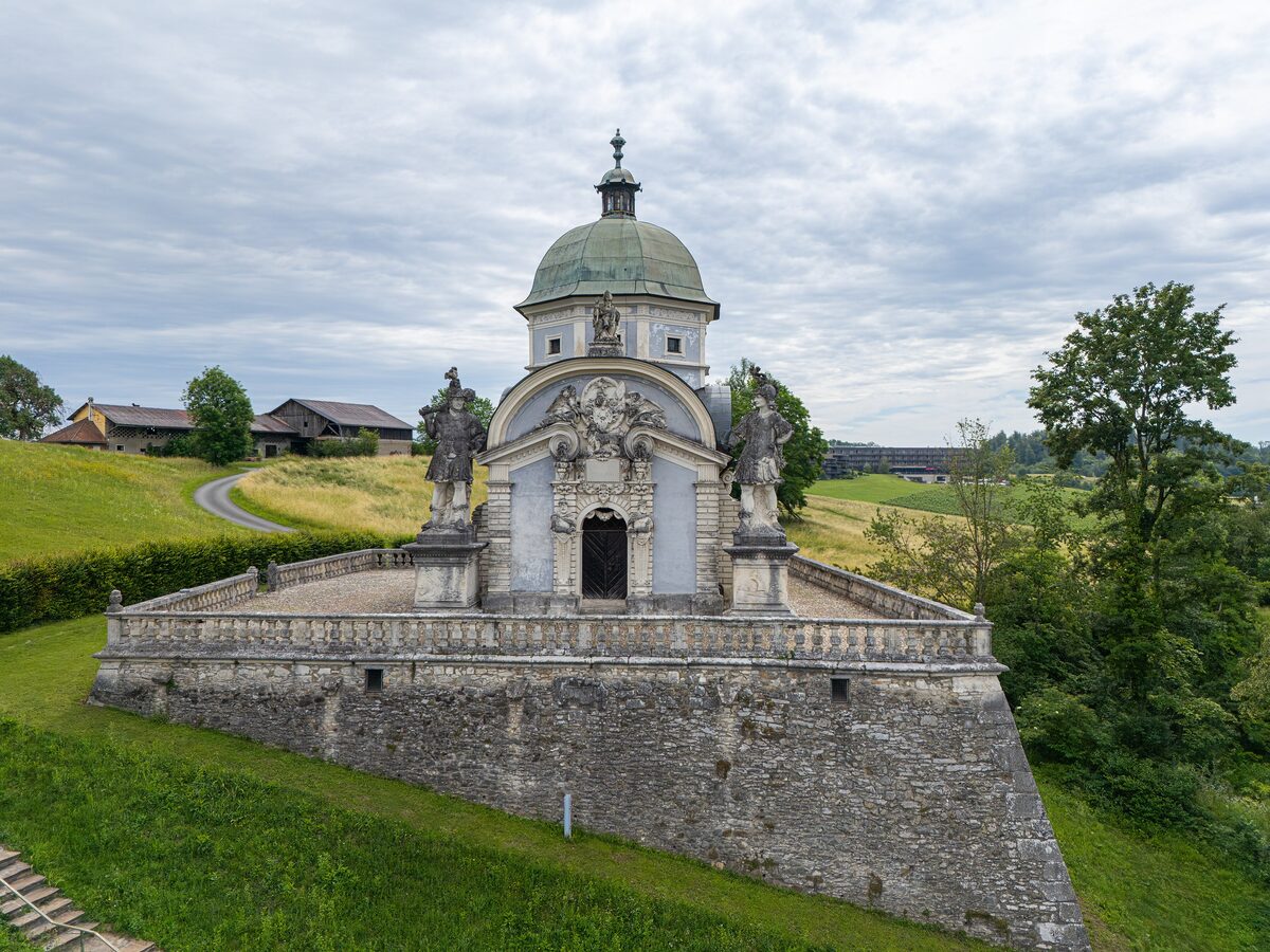 The domed Mausoleum of Ruprecht von Eggenberg on its terrace above Ehrenhausen, guarded by stone warriors