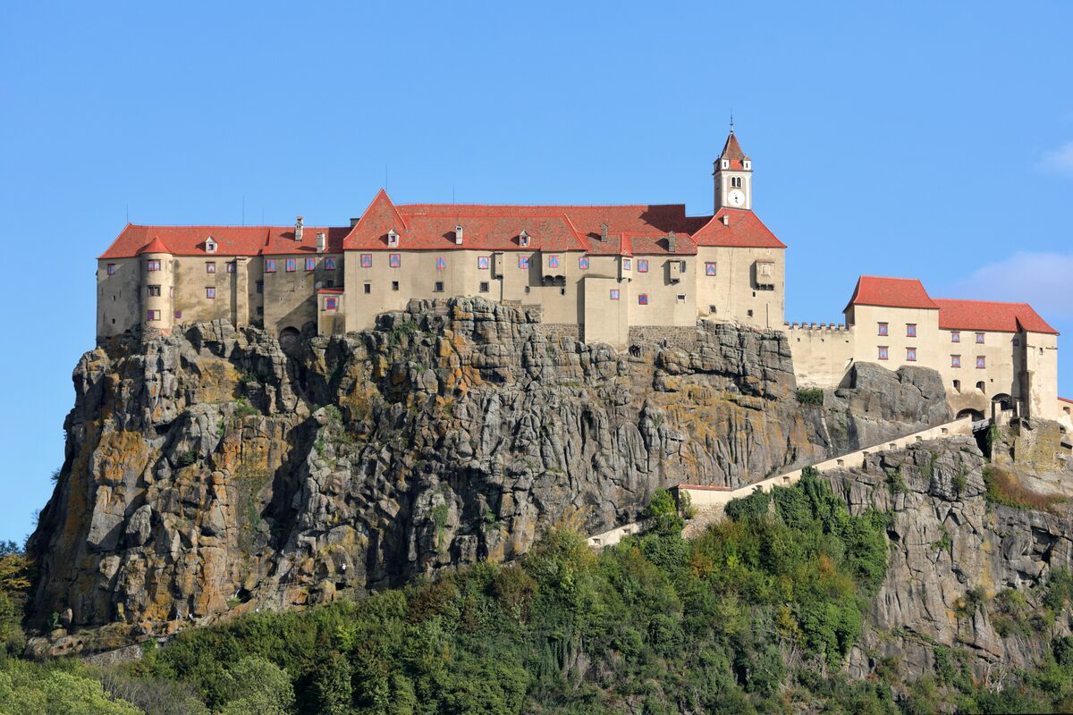 Riegersburg castle on top of its steep volcanic rock under a blue sky