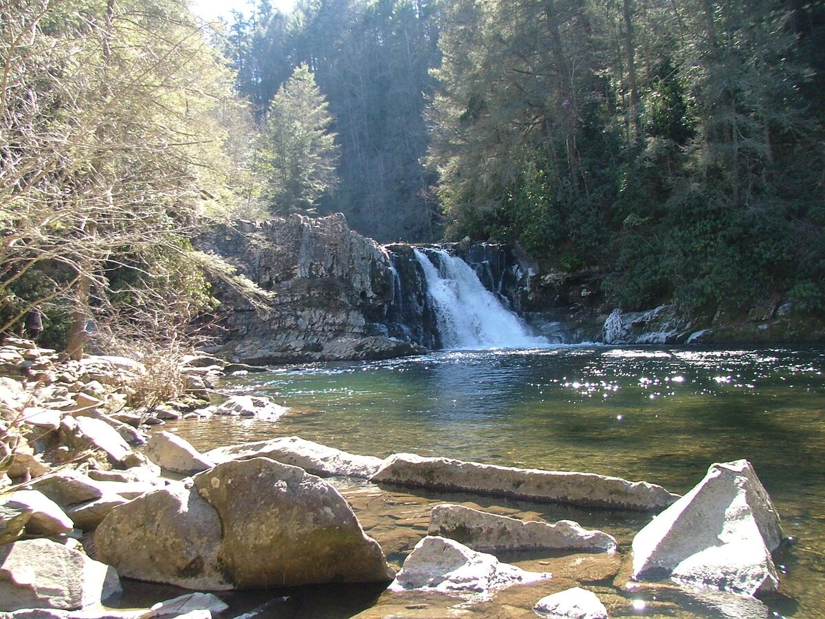 Abrams Falls dropping beside a rock wall into its wide pool
