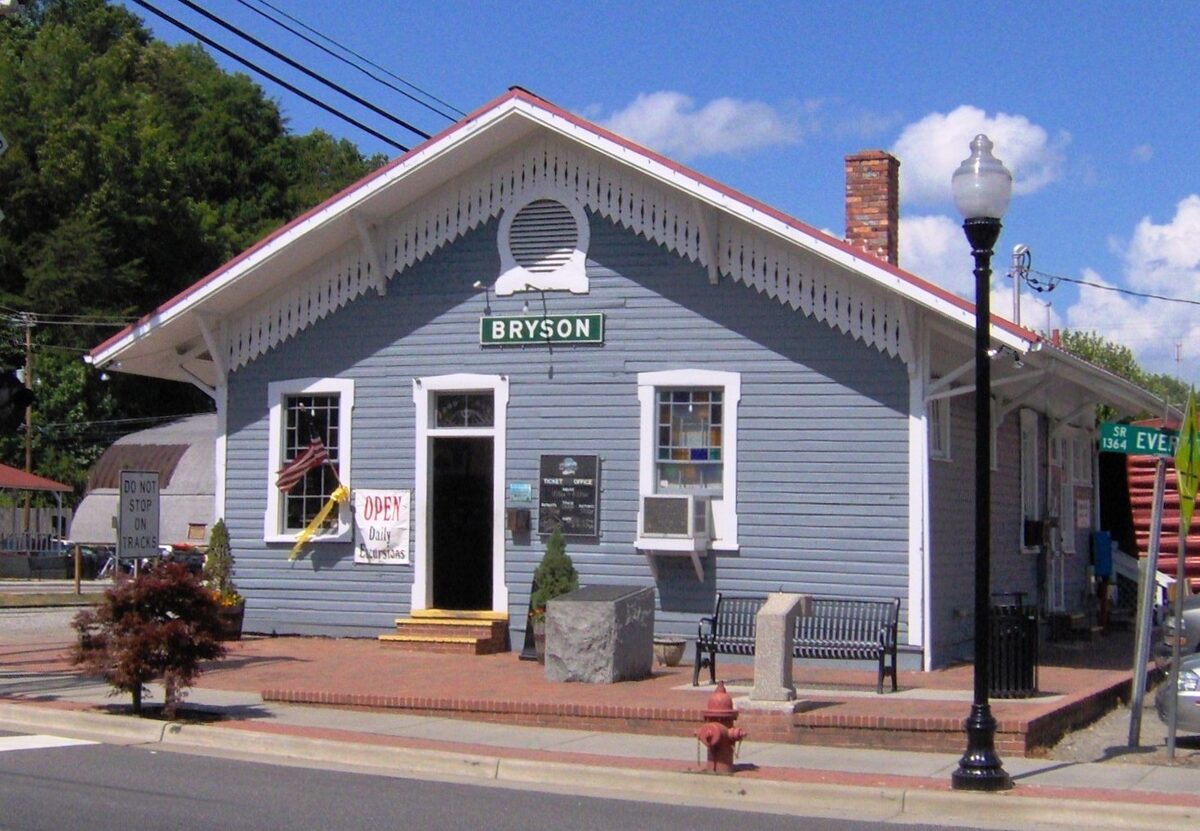 The blue Bryson City depot with its gabled roof on a sunny day